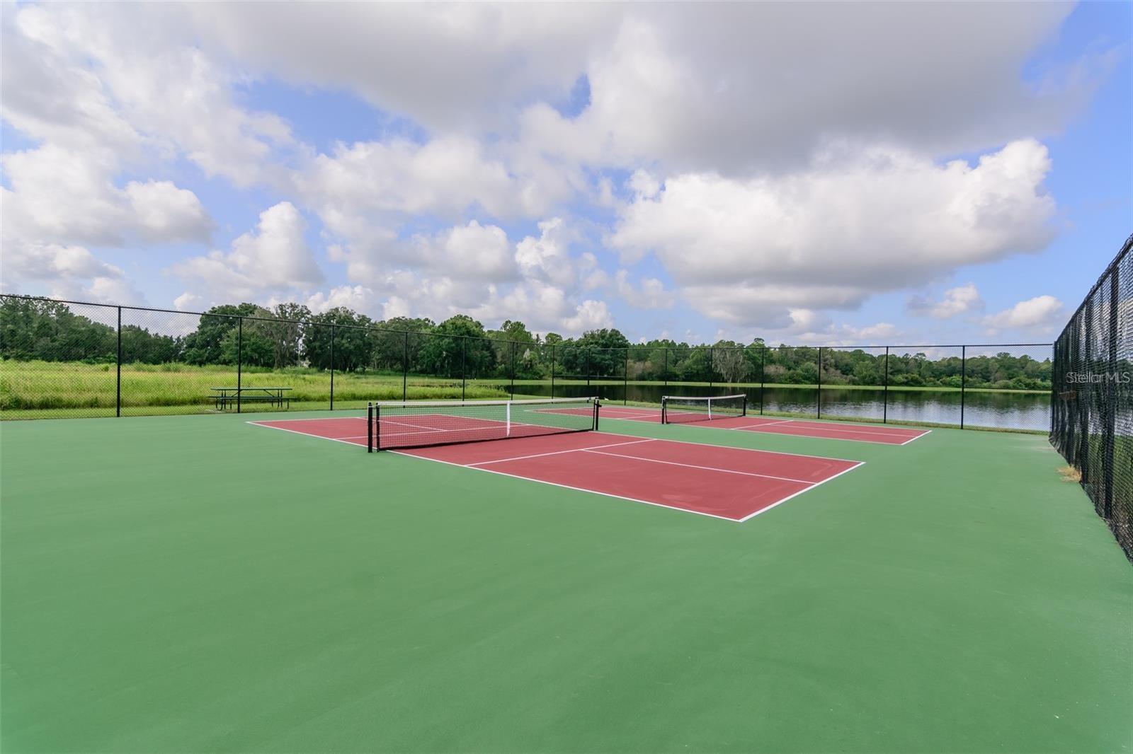 Community tennis court with water view