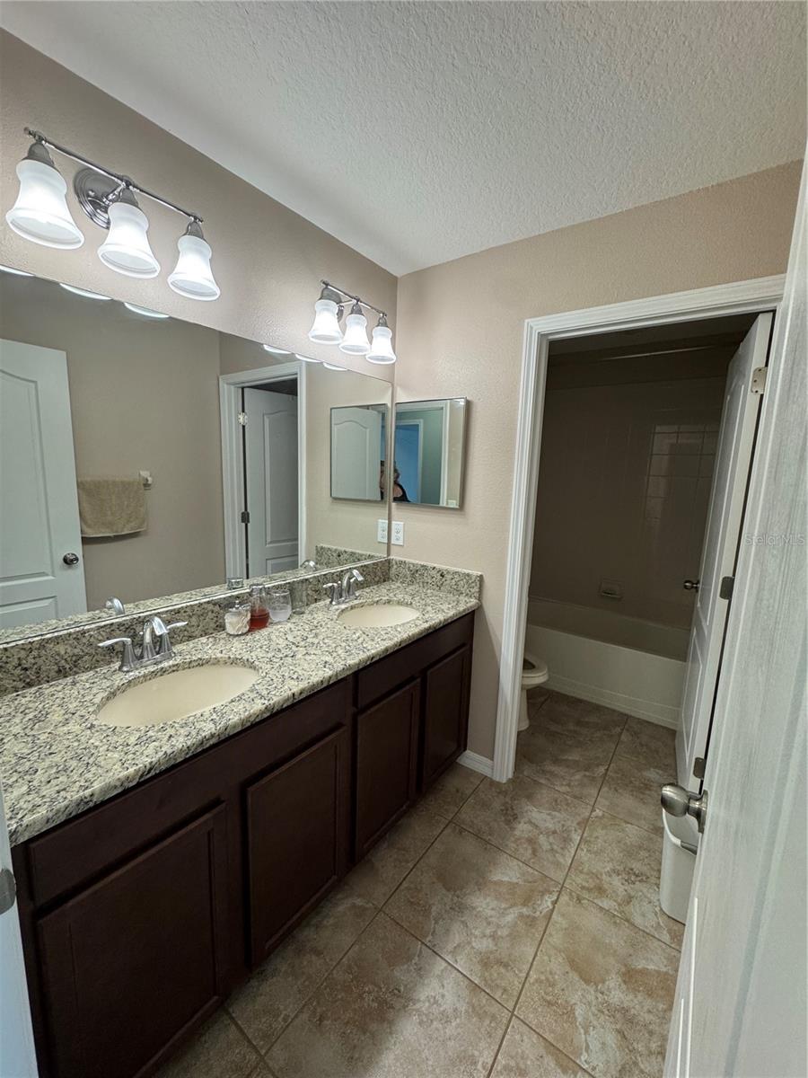 Hallway full bathroom on 2nd floor with his and her sinks, toilet and garden tub with their own door for privacy.