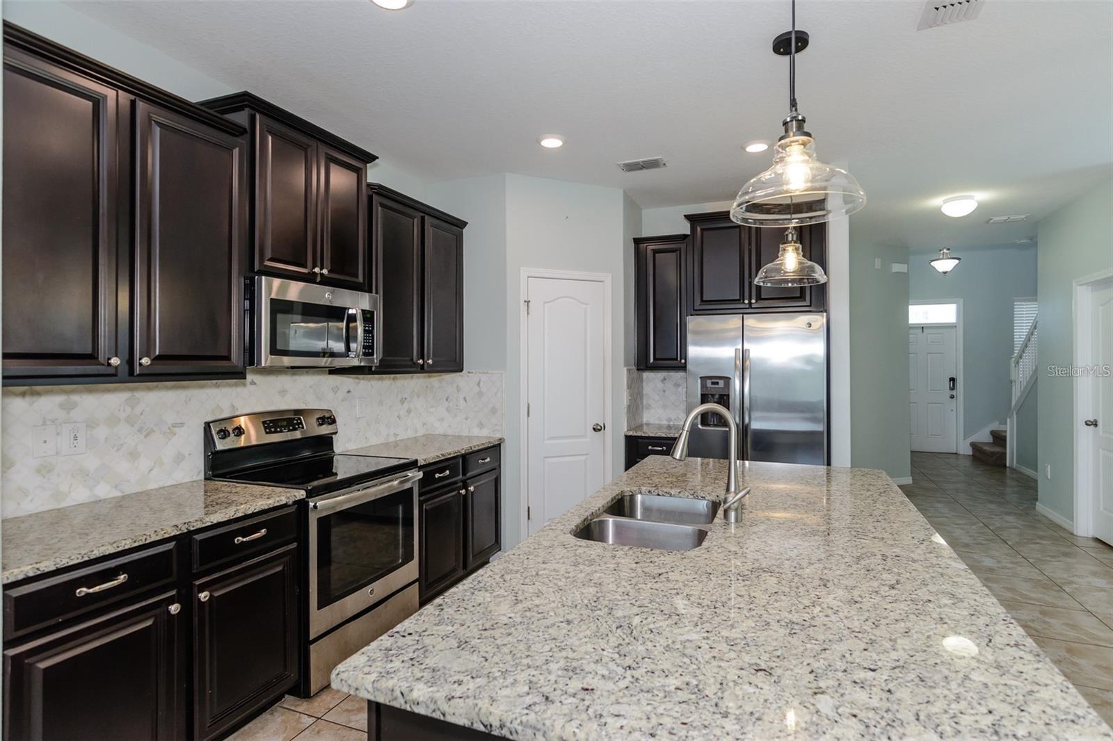 Espresso wood cabinets and granite counter top.