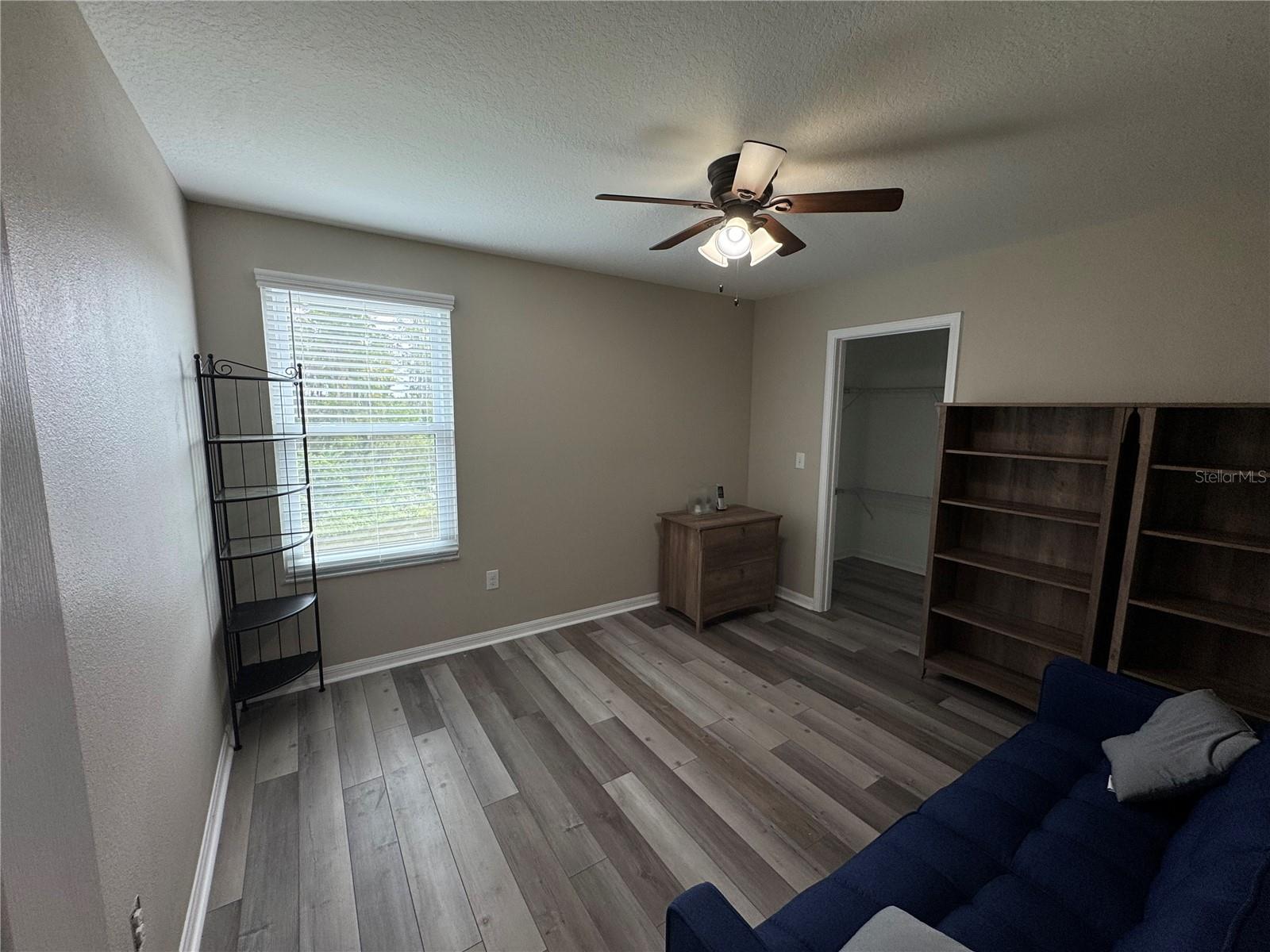 Bedroom to the right at the end of the hallway upstairs complete with walk-in closet and pond view.