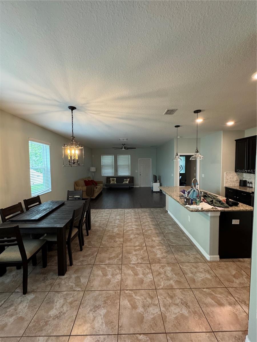 View of living room, dining room, and kitchen from the front entry way.
