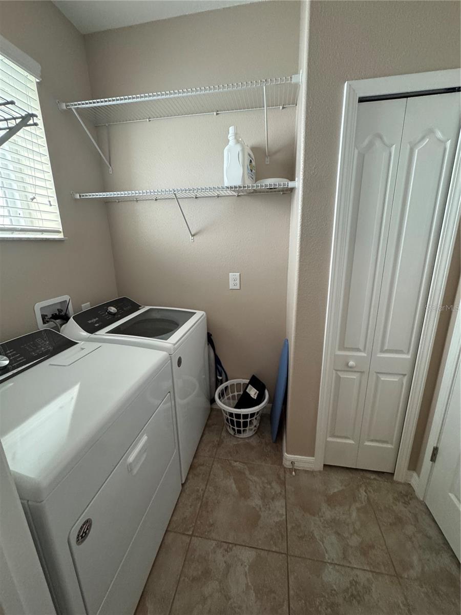 Laundry room with storage closet