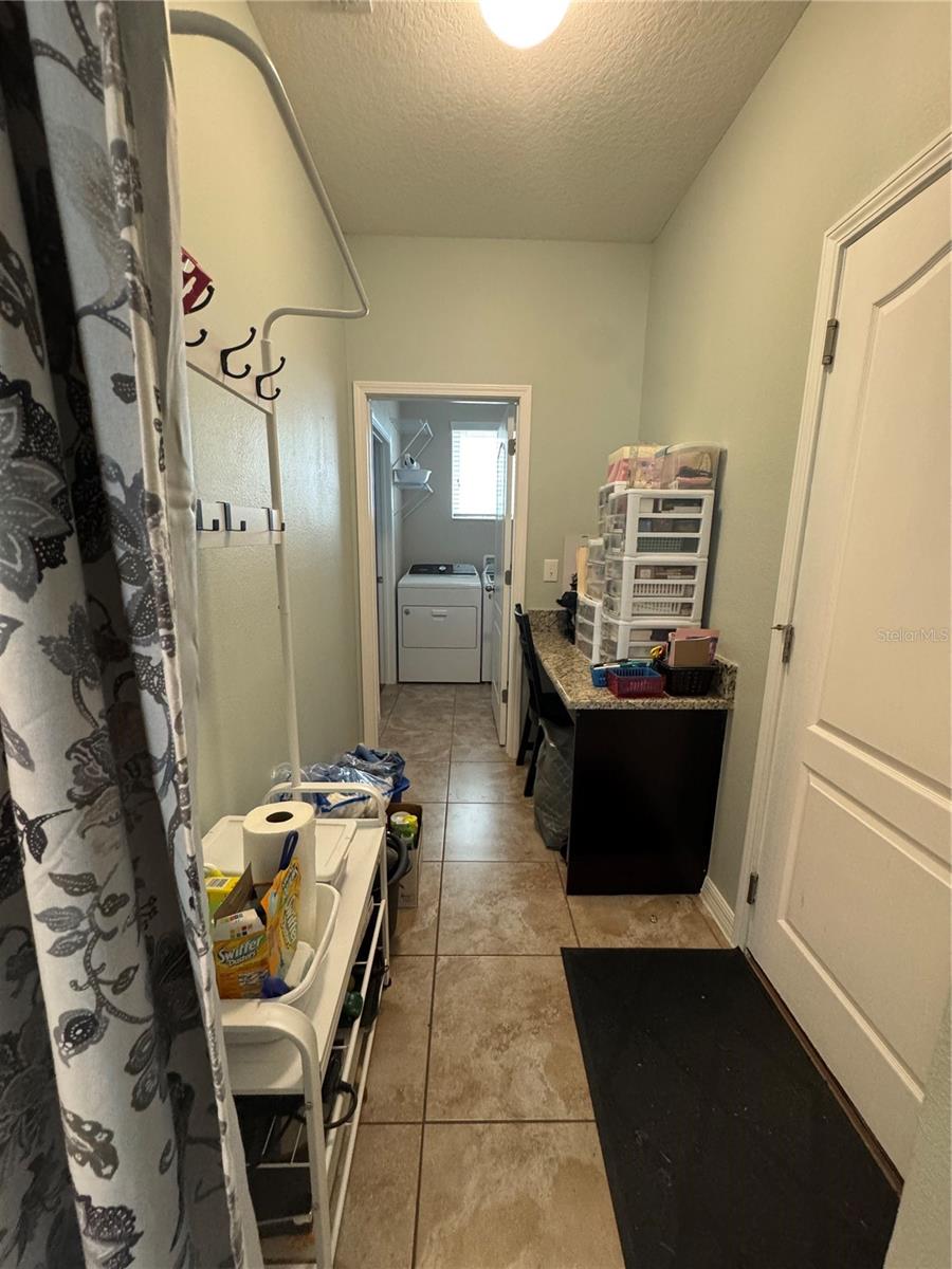 Mud room with entry way into 2 car garage and laundry room