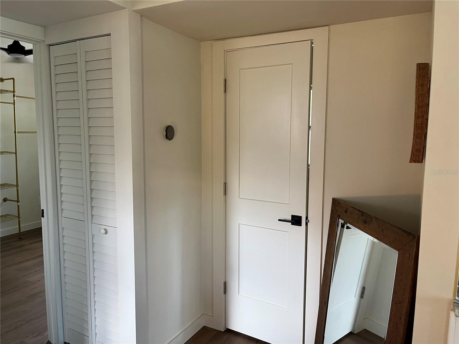 HALL AREA AC CLOSET AND BATHROOM DOOR