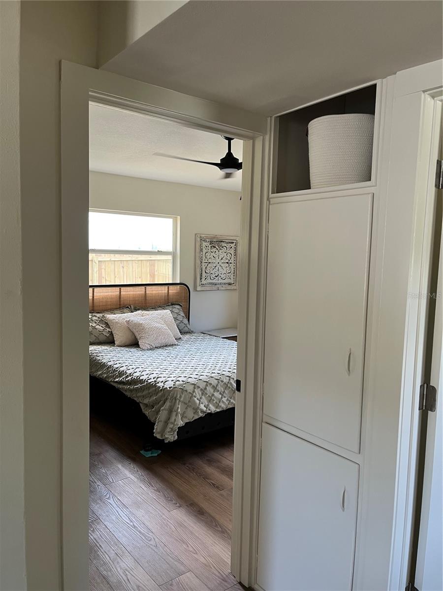 HALLWAY VIEW OF LINEN STORAGE AND PRIMARY BEDROOM