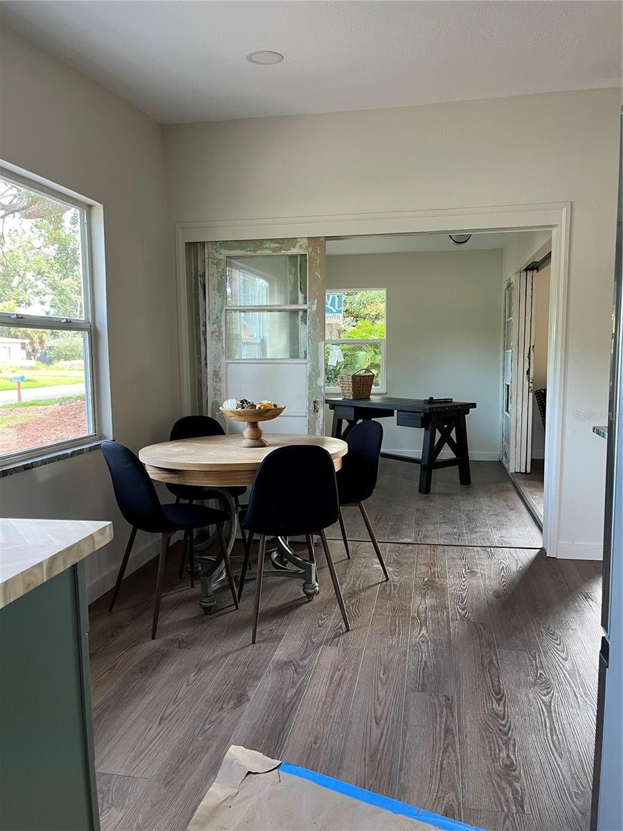 VIEW FROM SIDE DOOR IN CARPORT INTO DINING AREA AND INTO FLEX SPACE