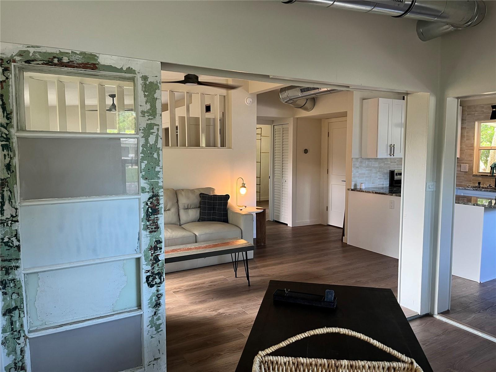 VIEW FROM FLEX SPACE INTO LIVING ROOM WITH DOOR WALL OPEN