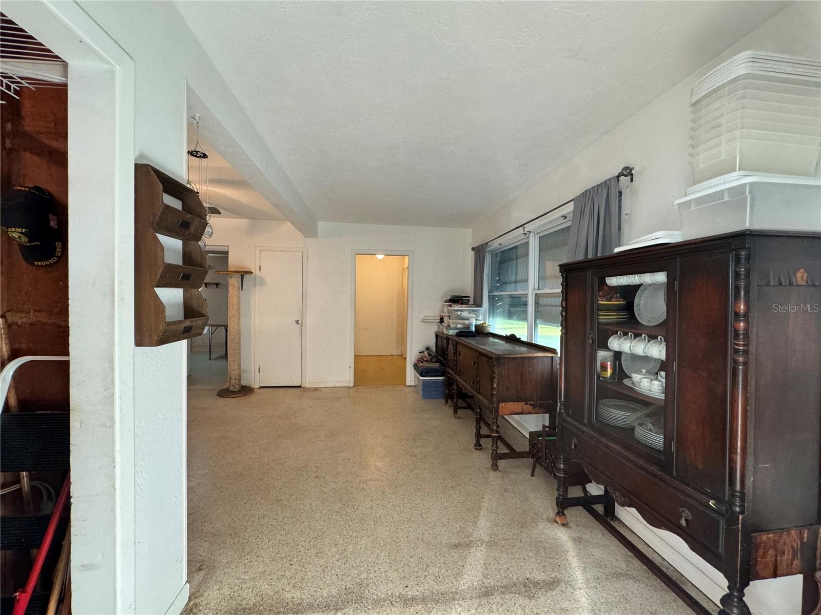 Entry from carport. Lighted doorway is the front door.