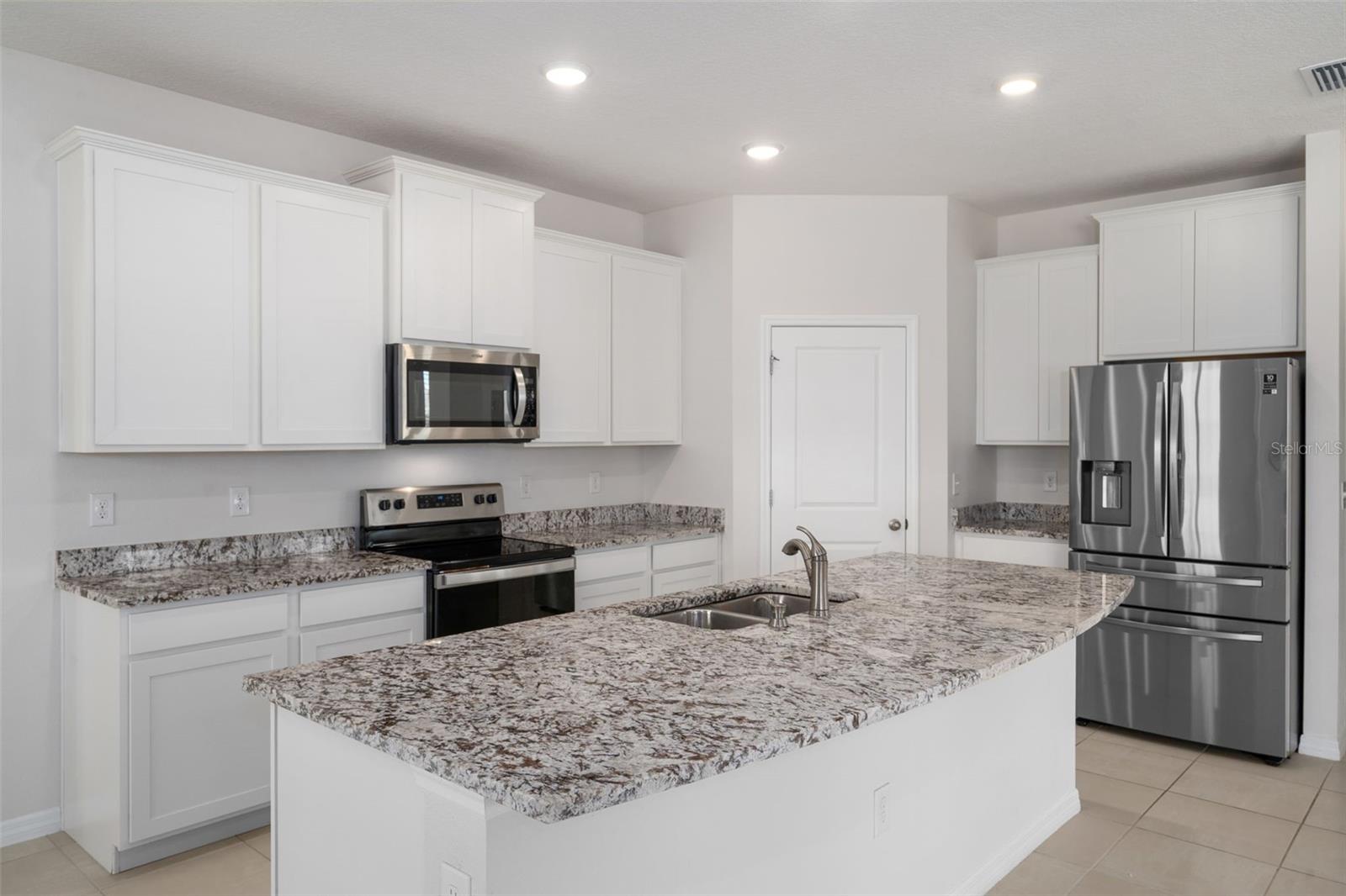 Breakfast bar - Granite and stainless steel appliances.