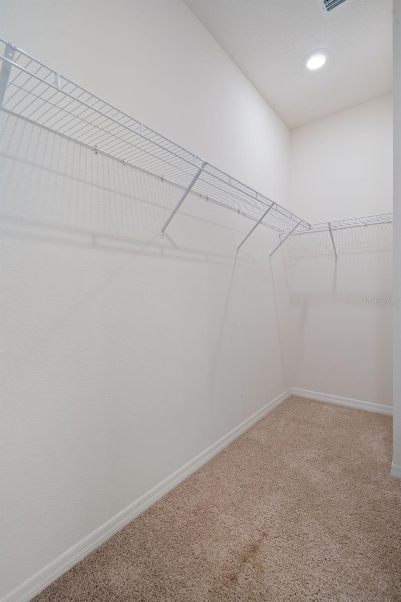 Oversized walk-in closet in primary suite.