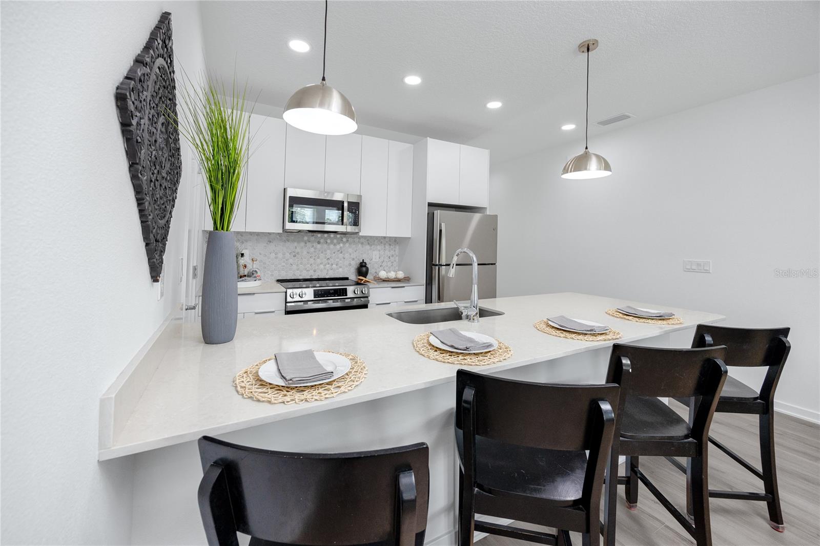 Modern cabinets with tile backsplash.