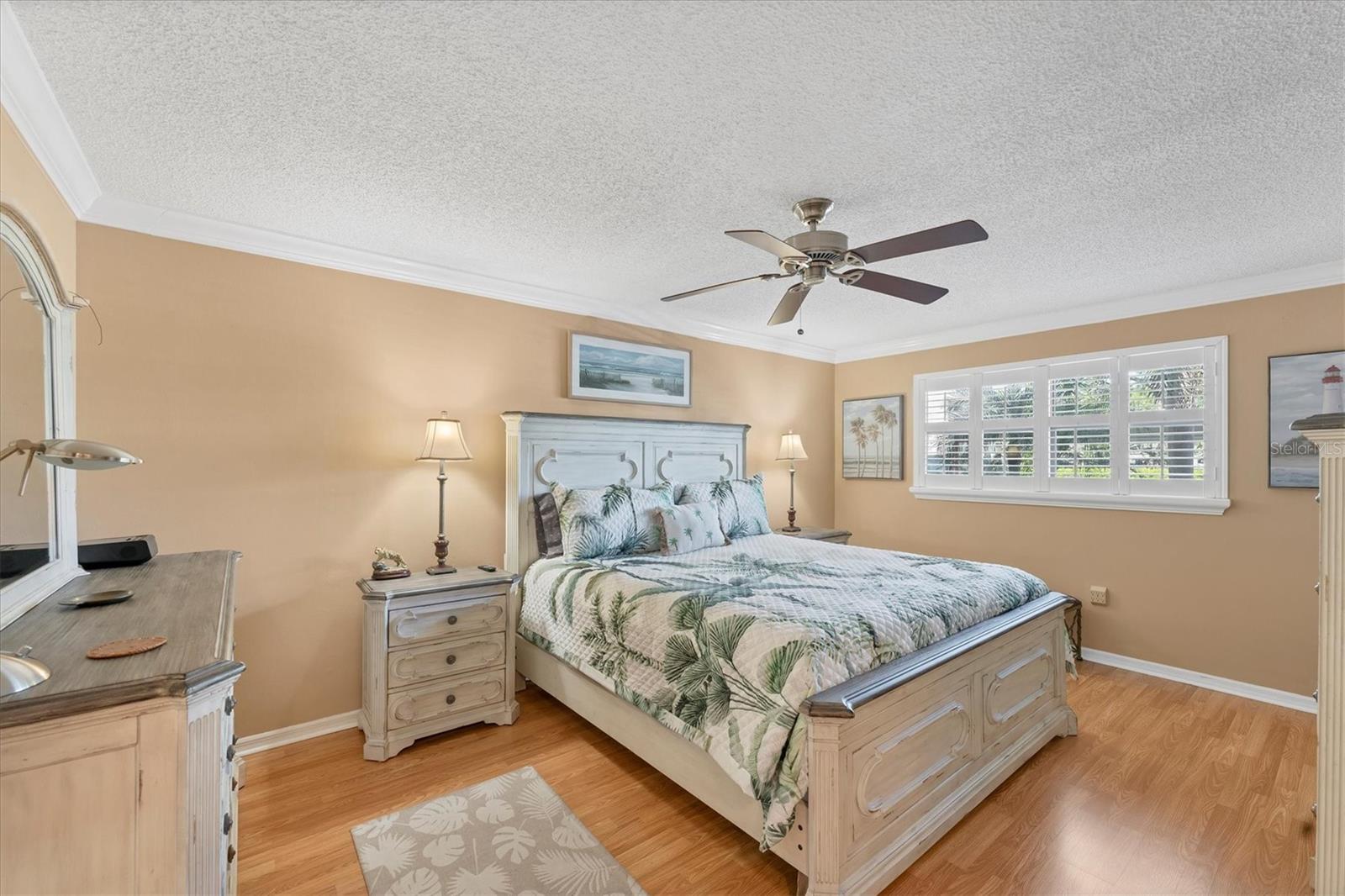 Master bedroom can accommodate a king size bed, two dressers, side table and offers laminate flooring, crown molding and ceiling fan. Wow!