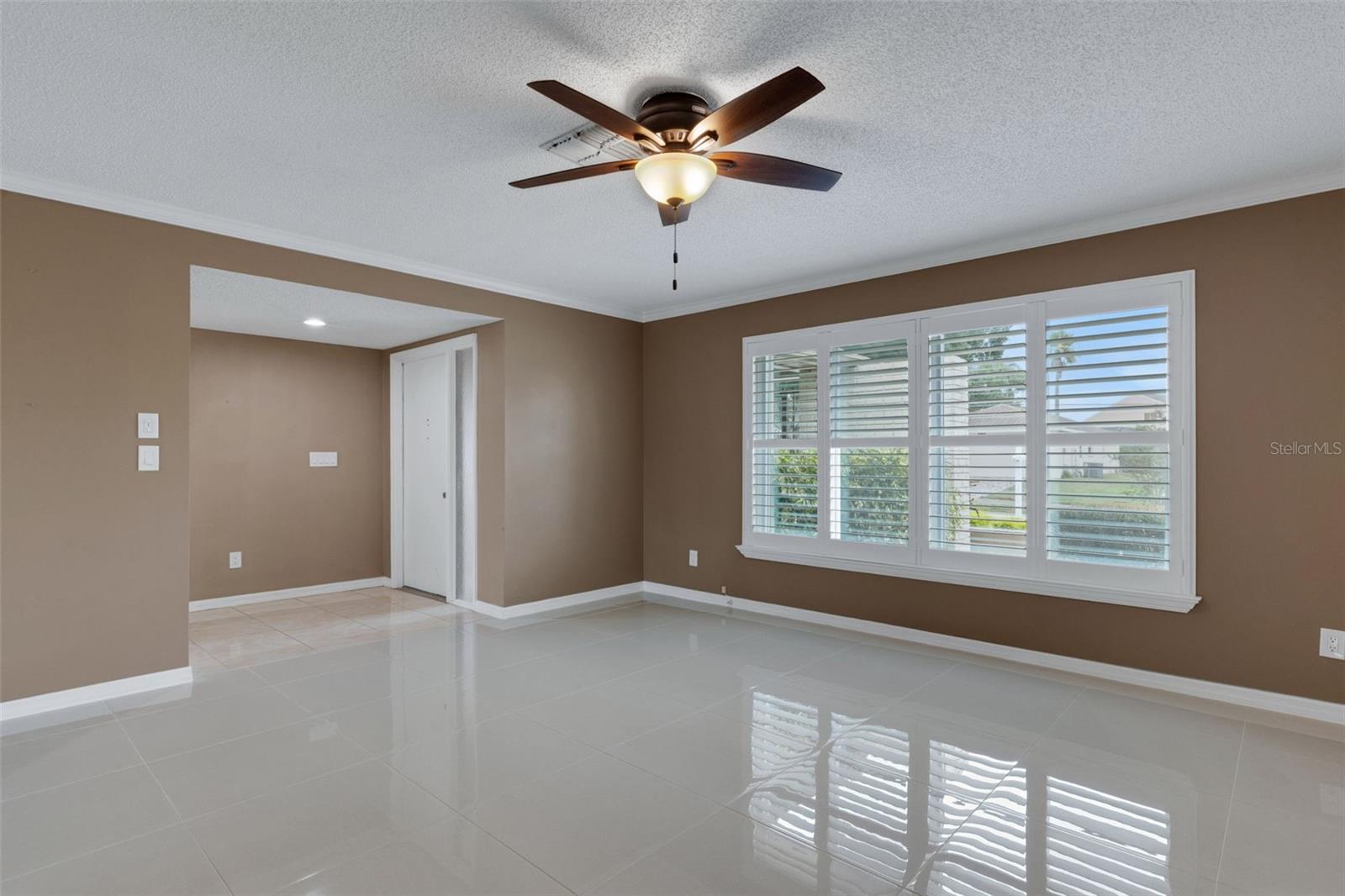 48 inch tile, Plantation shutters and Crown molding in the living room