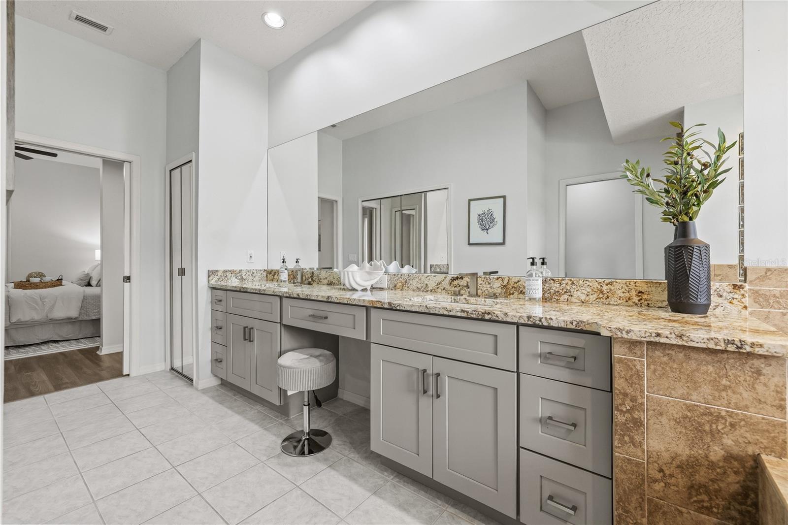 Primary bathroom with updated cabinetry and counters.