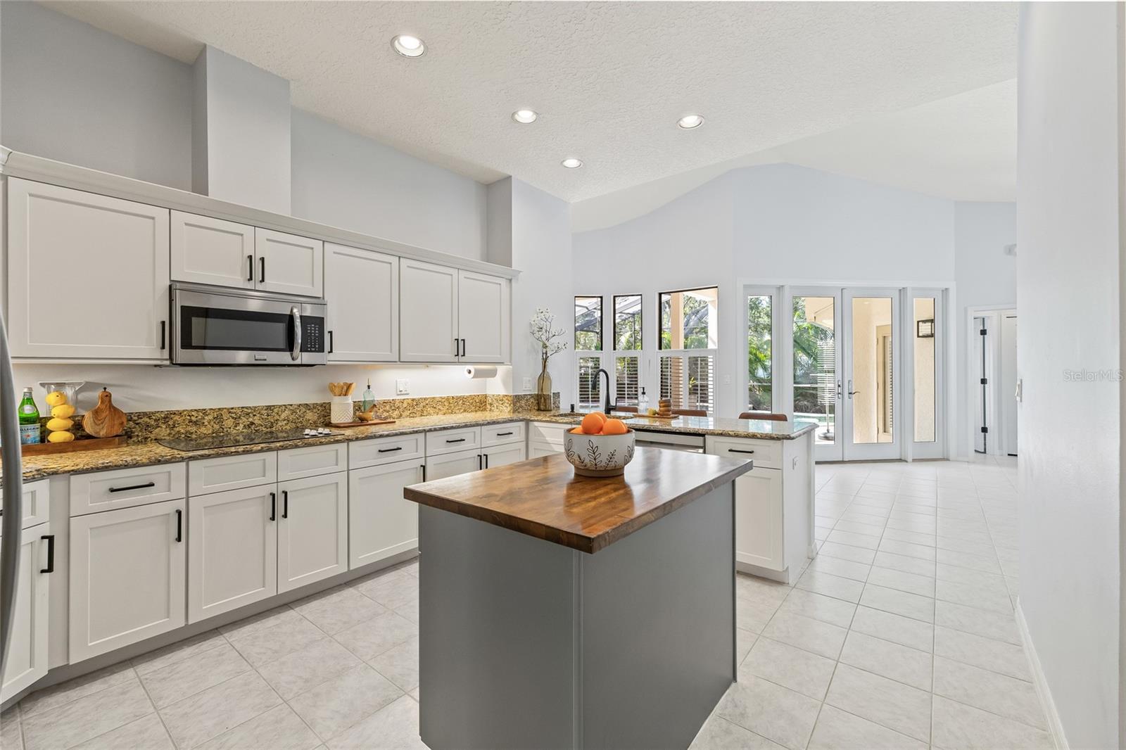 Spacious kitchen with views of the pool.