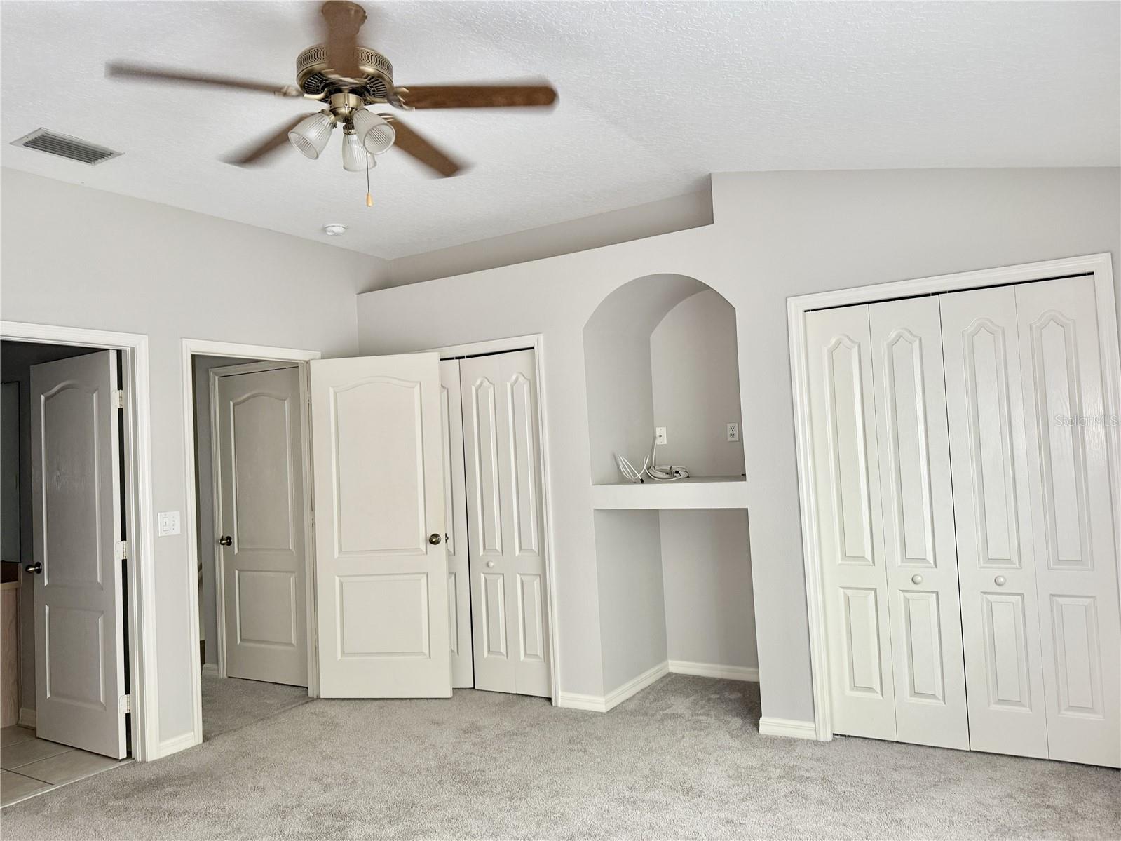 Primary Bedroom - Built-In Shelving and Double Closets