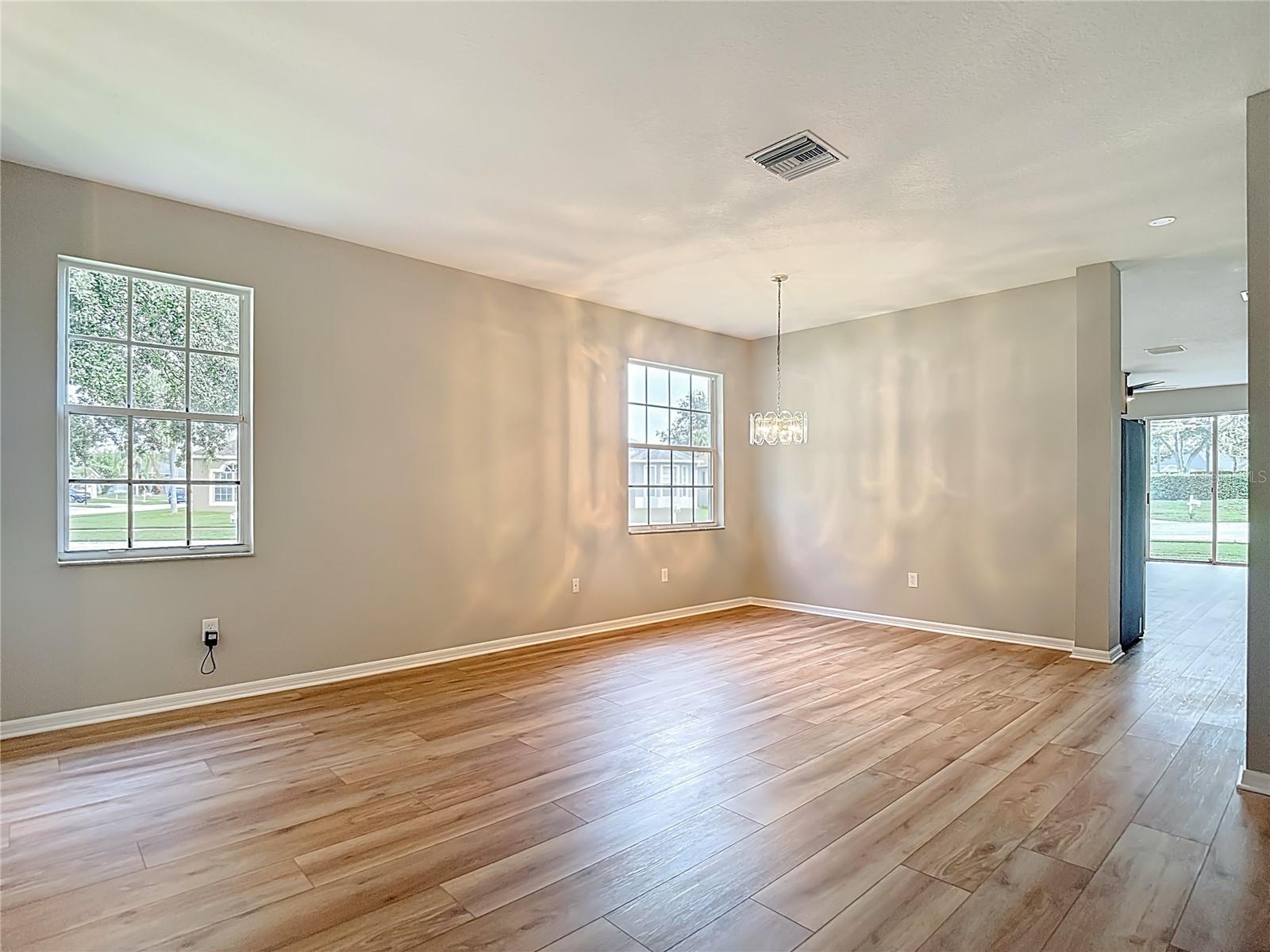 Living / Dining Room Combo.  New Flooring and Paint Throughout.