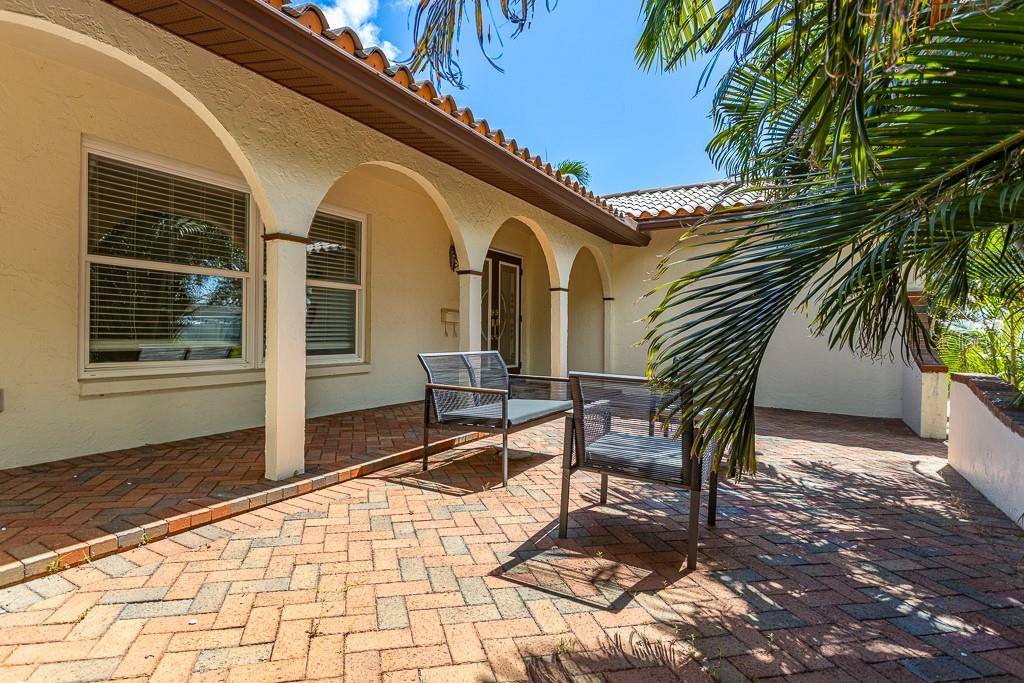 Courtyard enveloped by lush Arica Palm trees