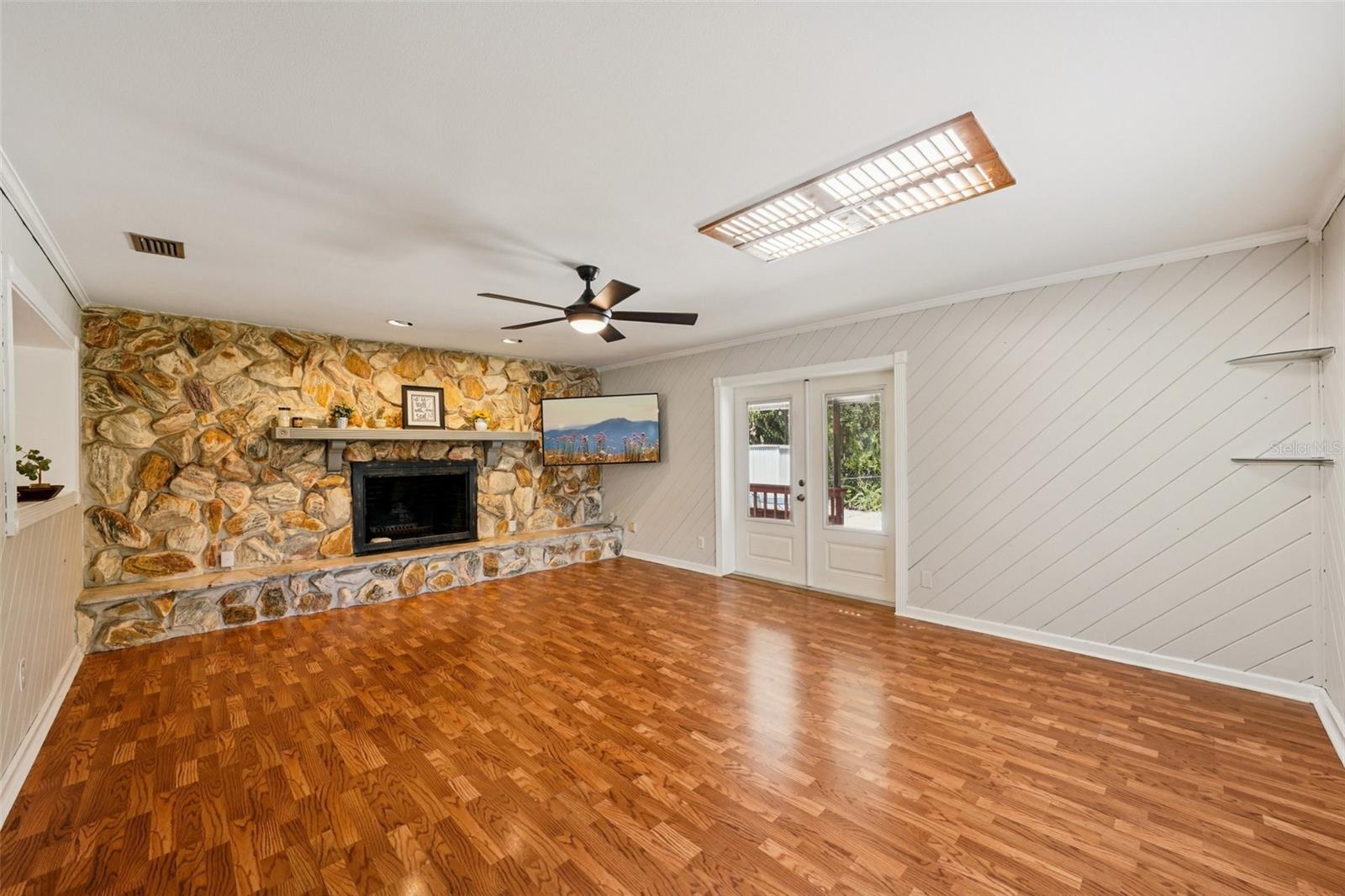 Den with wood burnig fireplace