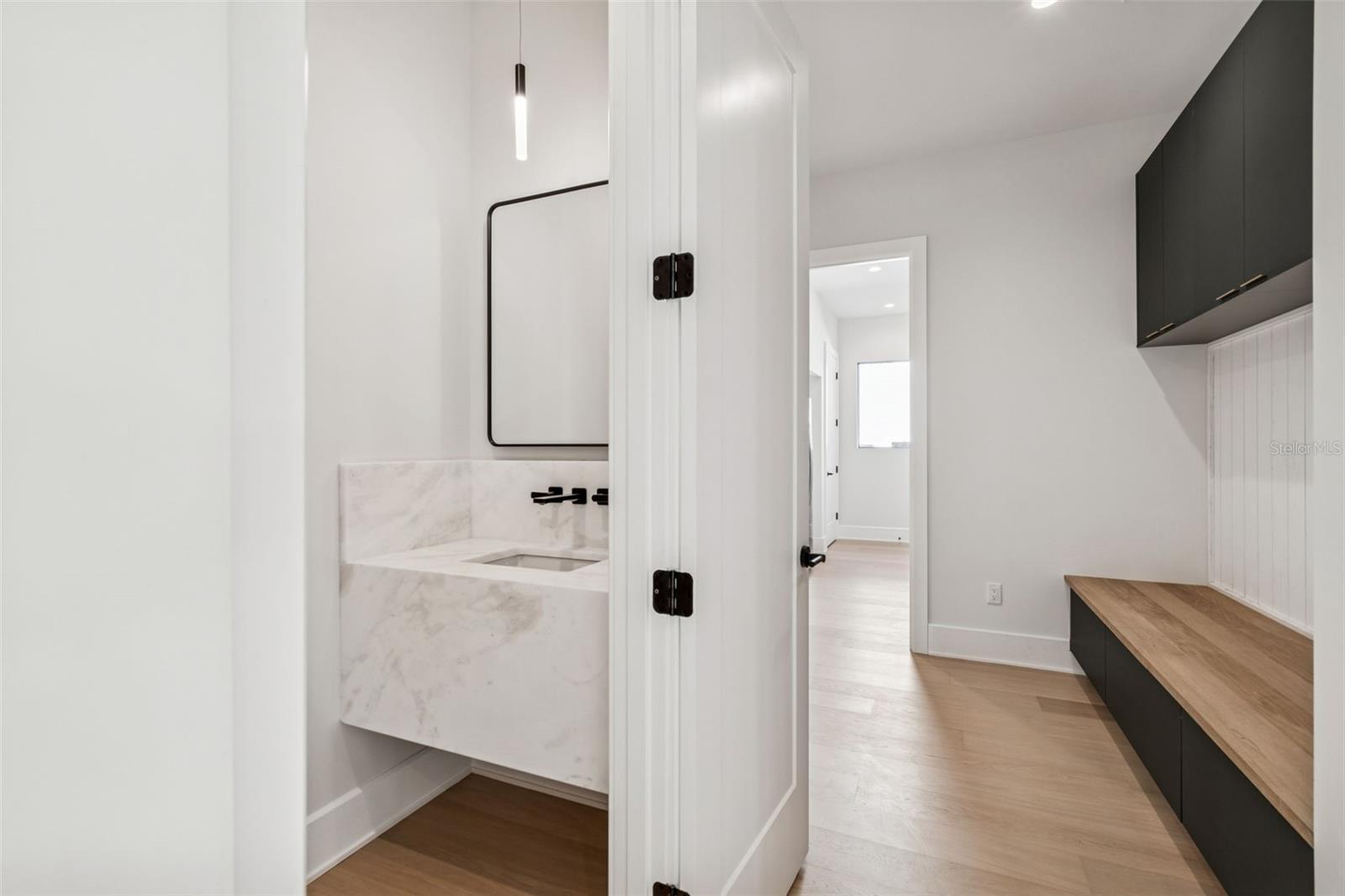 Powder bathg mud room leading to laundry