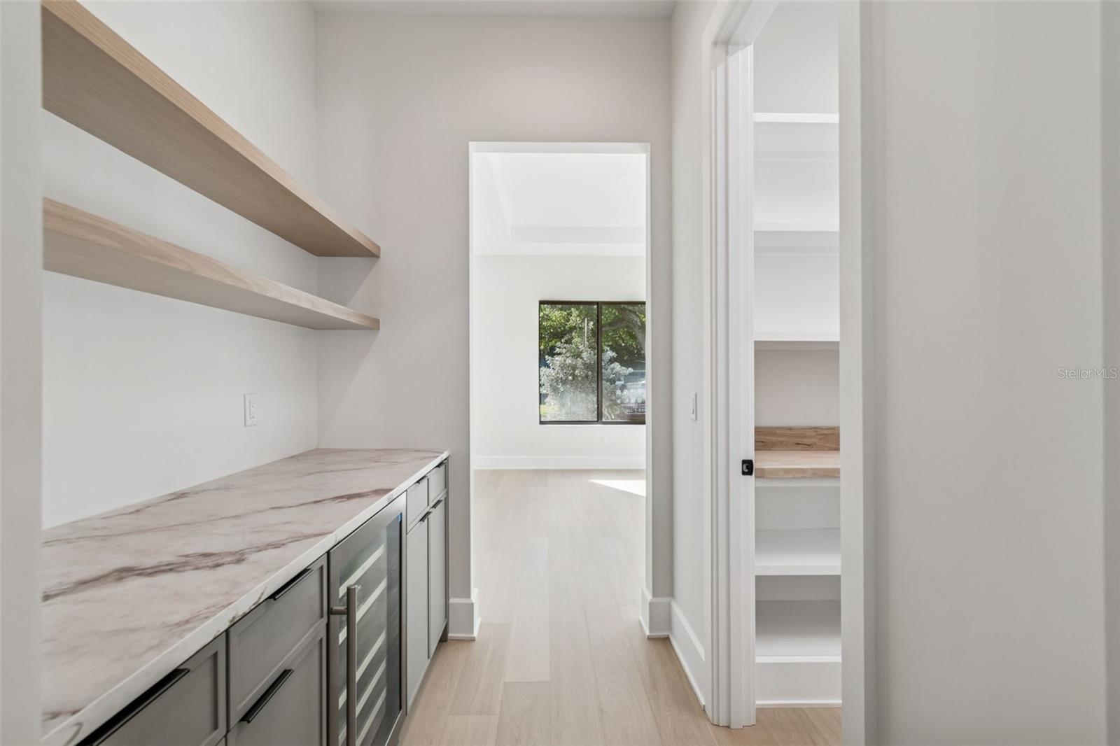 Butler pantry with walk-in pantry