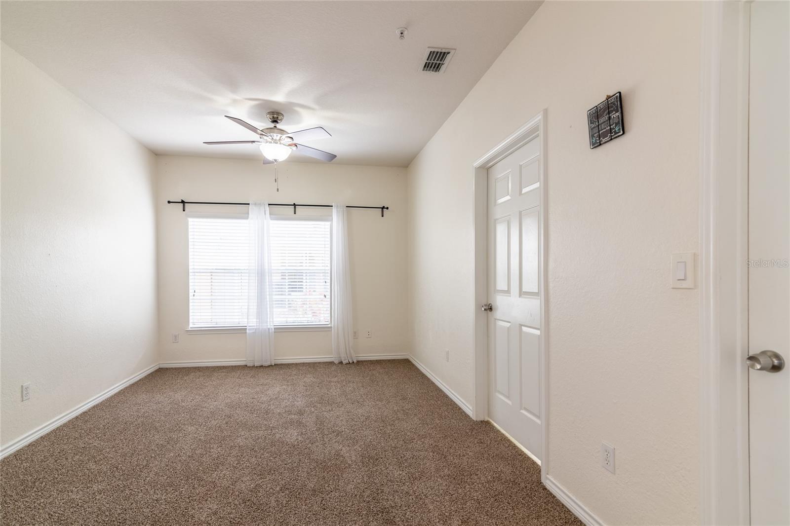 Primary Bedroom with bathroom and closet doors