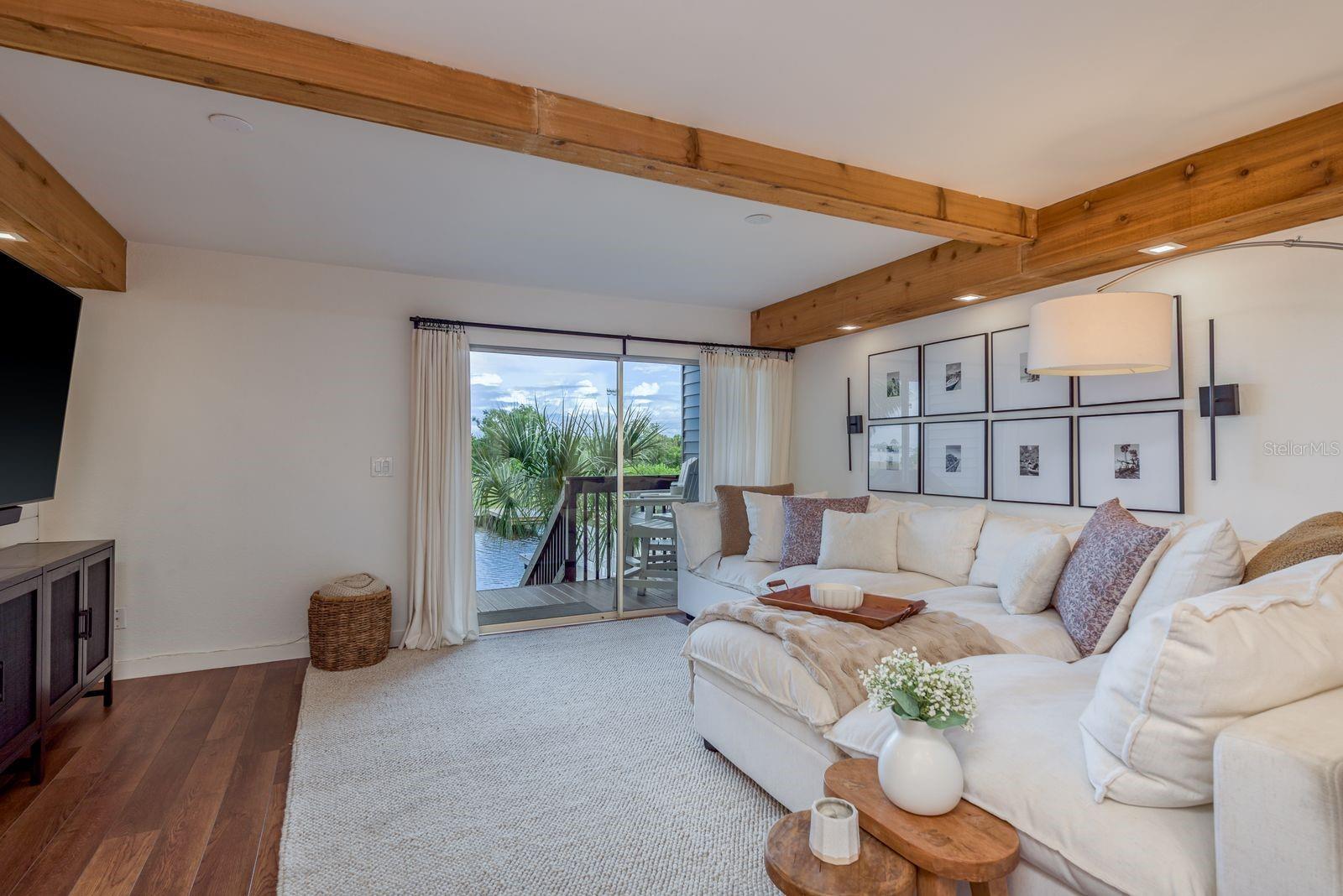 Living Area w/ Rear Balcony and Direct Access to the Waterfront