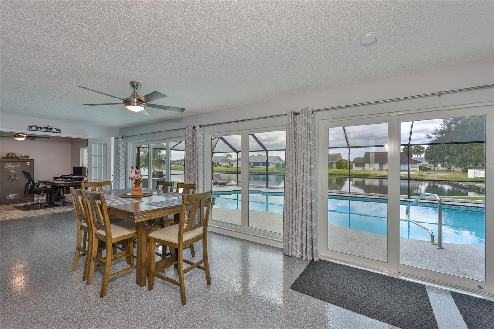 The dining area is huge with panoramic views of water.  Open the 2 triple sliders for everyone to mingle in and out of the home.