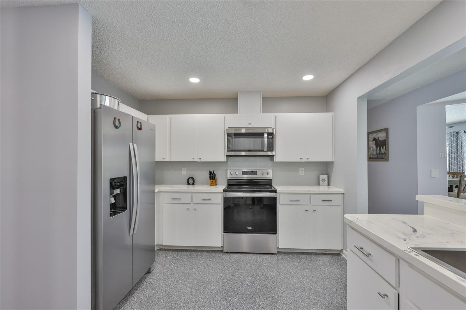 Another view of the kitchen with neutral colors, clean and bright!