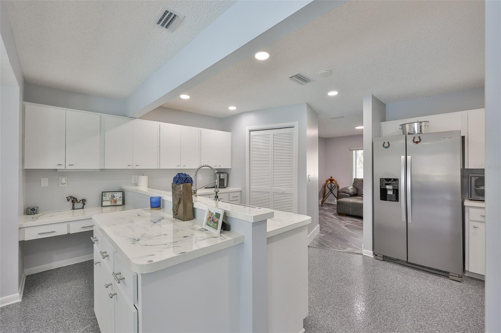 The kitchen is large for multiple cooks and different areas for food preparation.