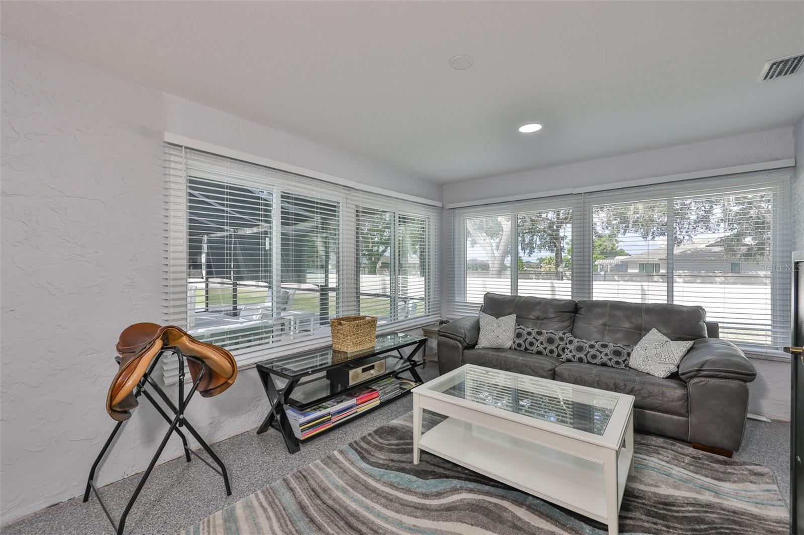 An extra bonus area has been converted from a lanai to another room which is perfect for crafts or a game room, as the natural Florida sunshine flows throughout the room and has a full view of the pool, water and expansive green space outside.