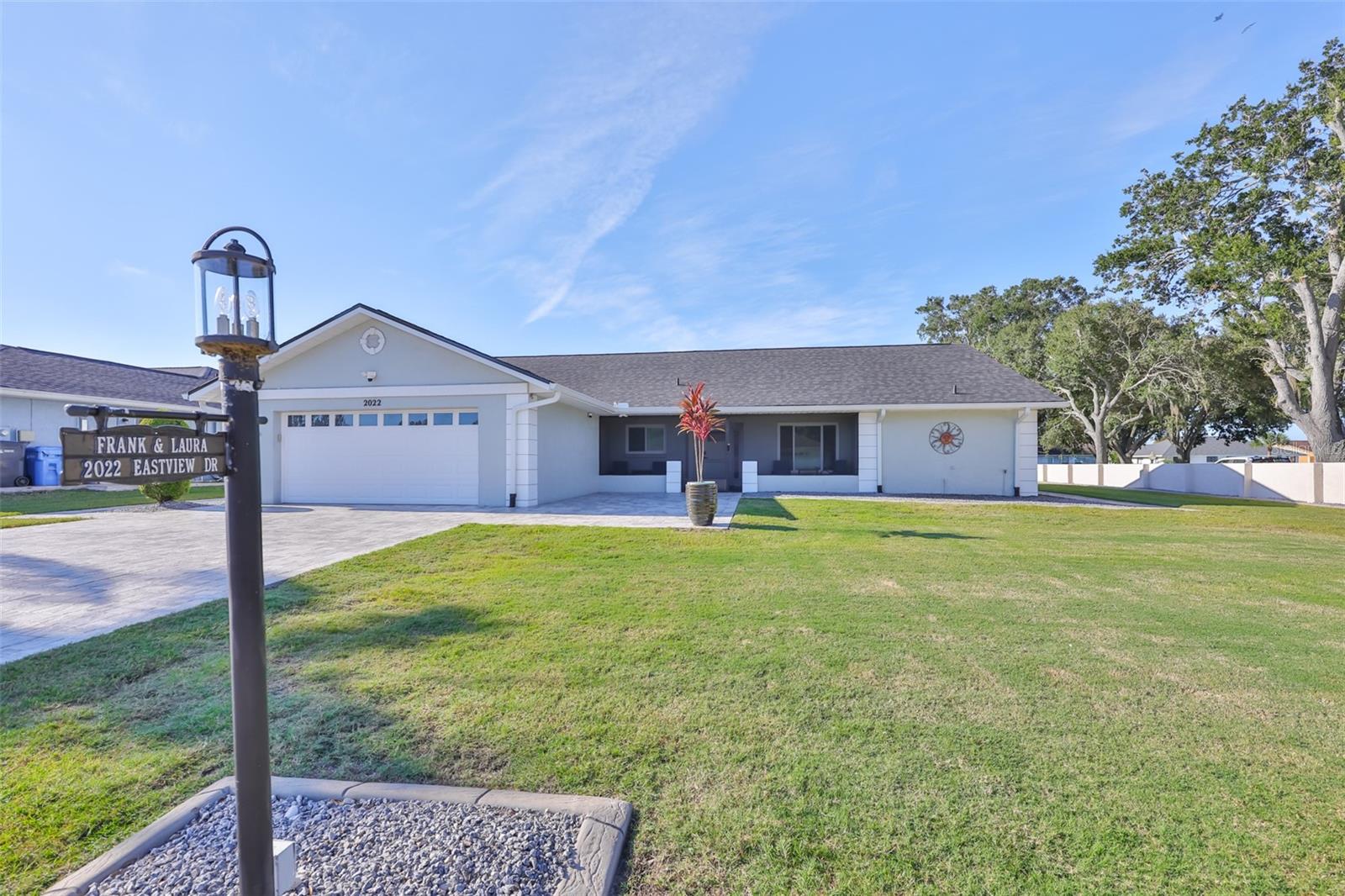 A large corner lot with minimal landscaping (for easy maintenance) and lots of room if you wish to garden, play, or plan future projects.