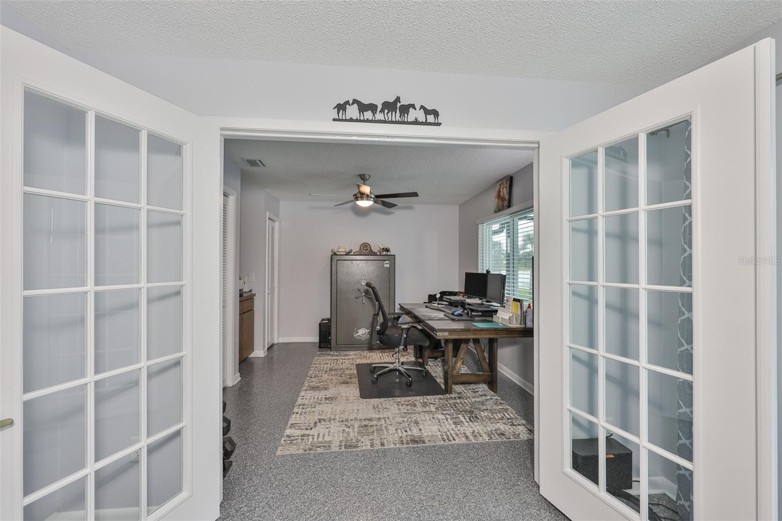 French doors lead to Bedroom #3 from the dining/living area.