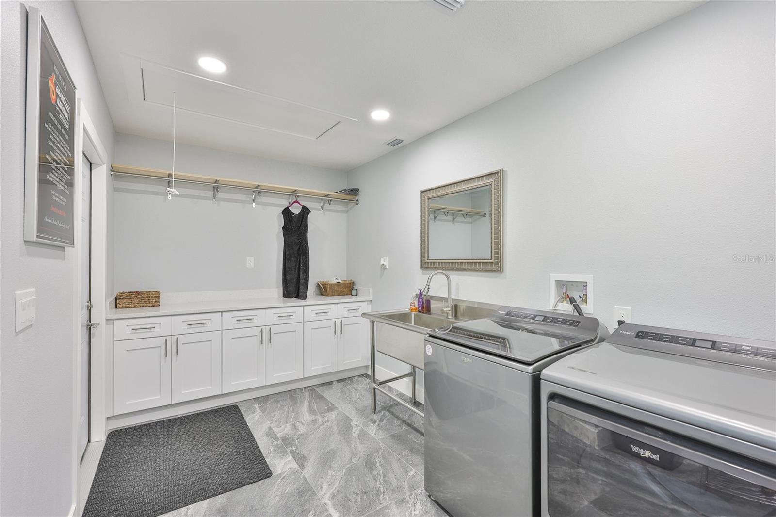All newer appliances, utility sink and plenty of laundry room storage as well as a folding counterspace leads out to the garage.