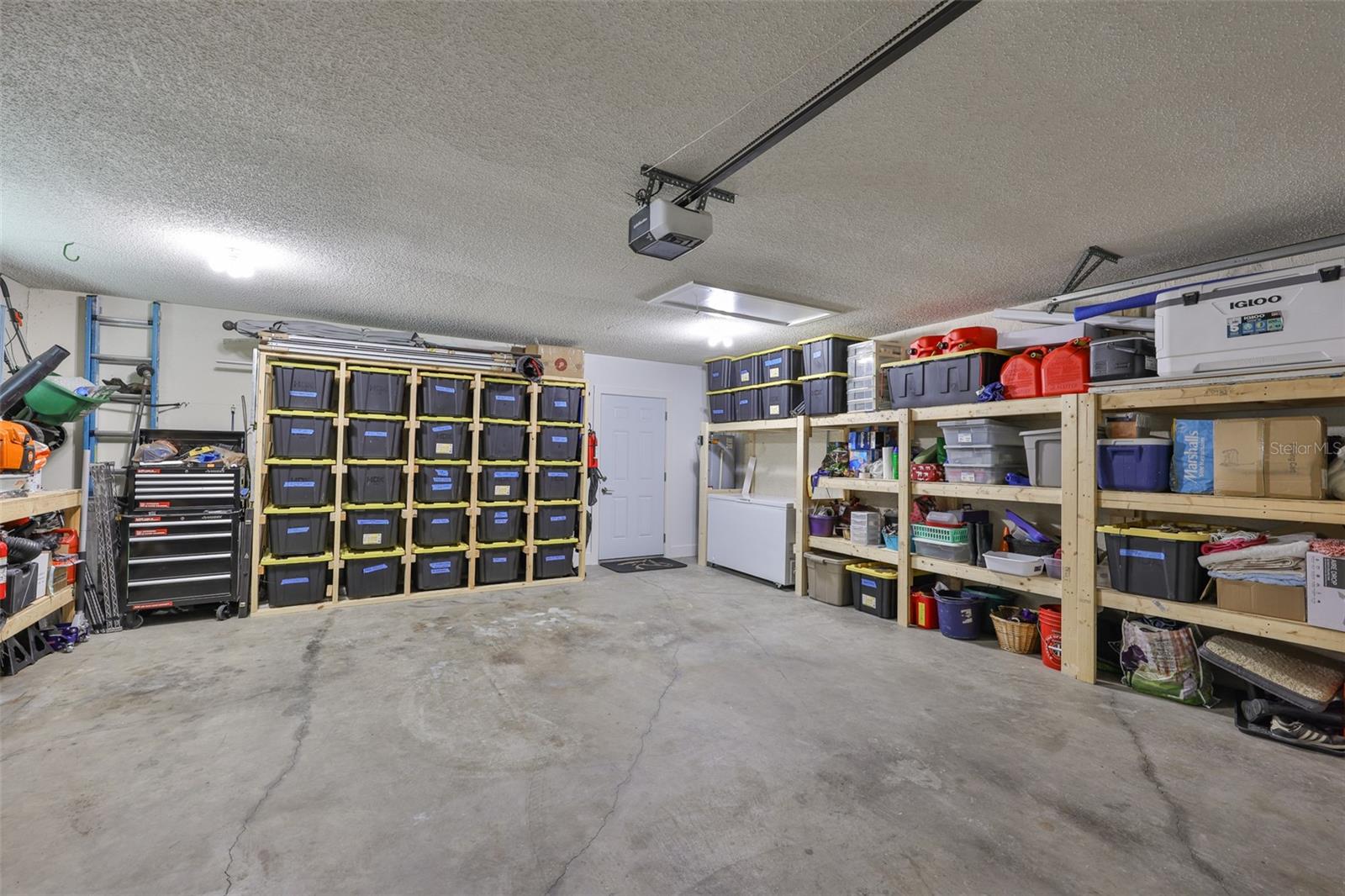 Large 2 car garage with ample storage that easily still fits 2 cars.