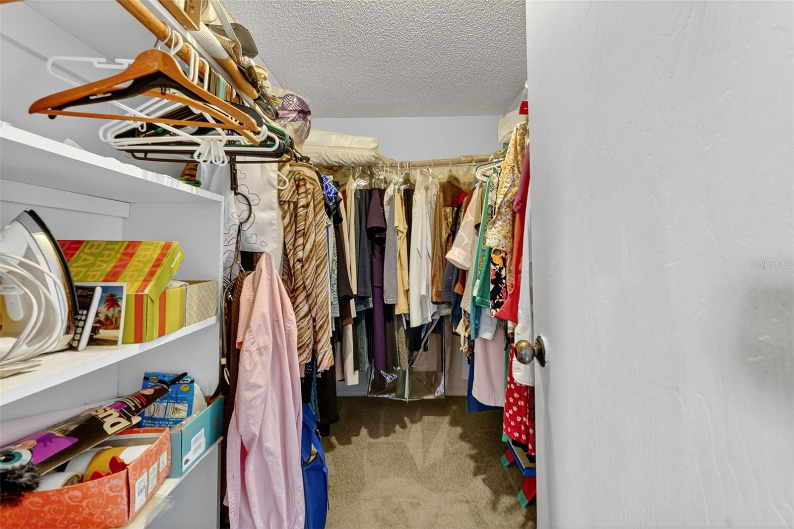 Walk in closet in primary bedroom