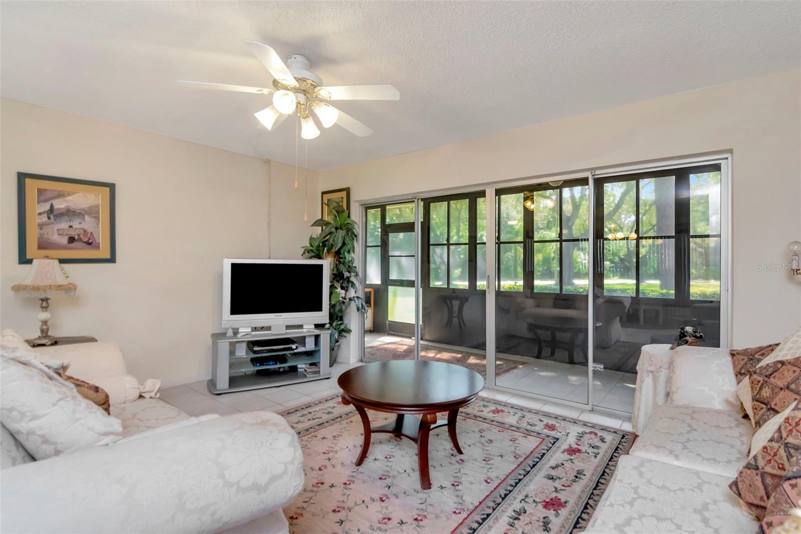 Large living room with views out to enclosed Florida room and outside