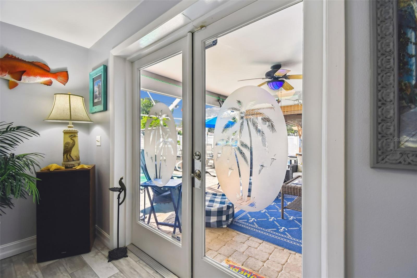 French doors leading to the outdoor living room, kitchen and swimming pool and spa.