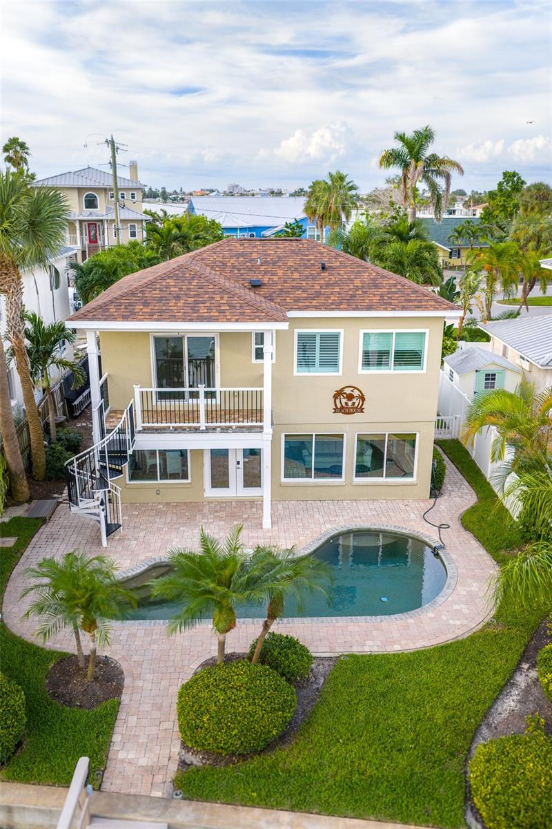 The backyard is the perfect oasis to lounge poolside or entertain in the lovely outdoor environs.