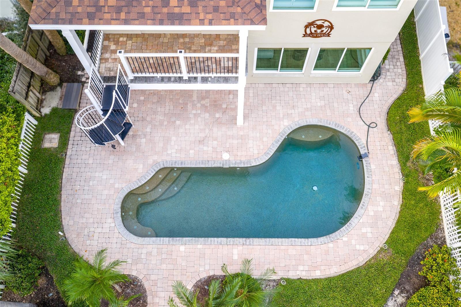 Swim in the gorgeous pool for your morning exercise from the private spiral staircase off the primary bedroom