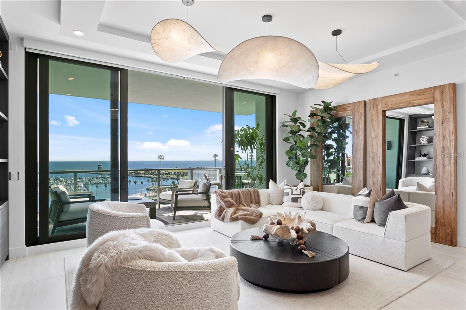 From the gorgeous designer lighting and detailed ceiling, to the stunning water views, to the perfectly curated interiors, this condo has it all!