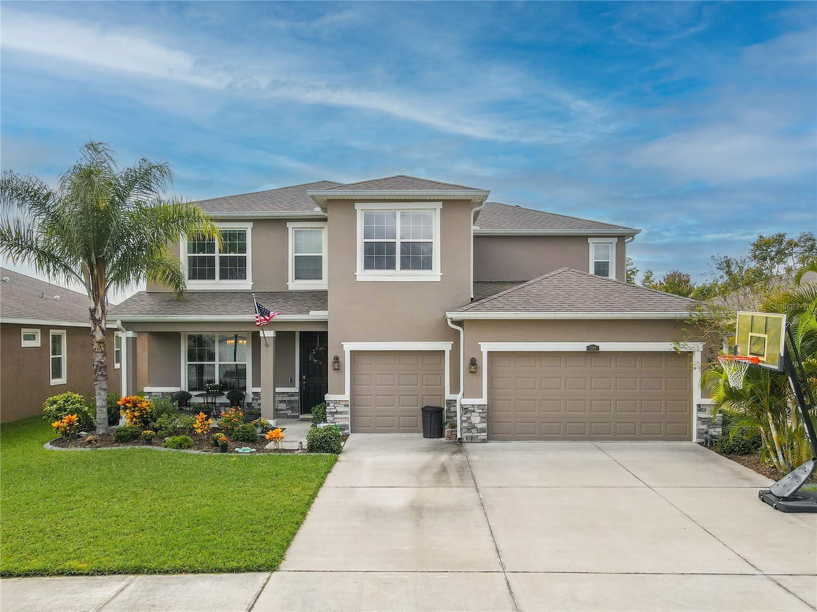 Stunning curb appeal with stacked-stone accents, lush landscaping, and a three-car garage in the sought-after Union Park community.