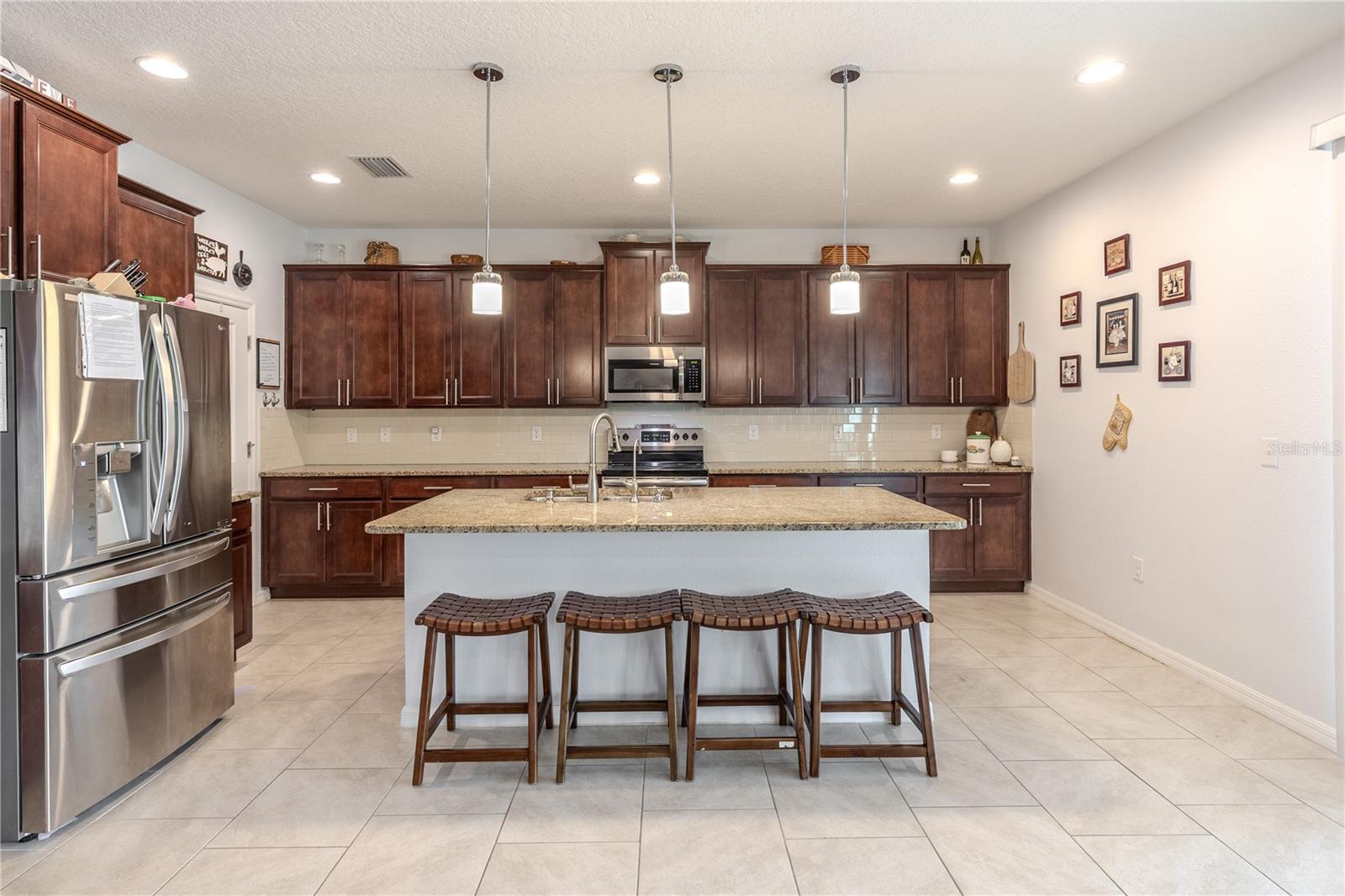 Spacious open-concept kitchen and family area with clear sight lines, easy flow, and plenty of natural light.