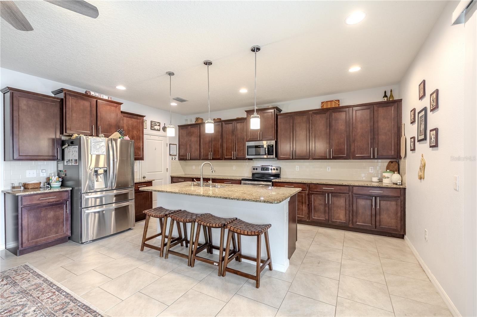 Expansive kitchen design offering abundant cabinet space, a walk-in pantry, and a generous island for casual seating.