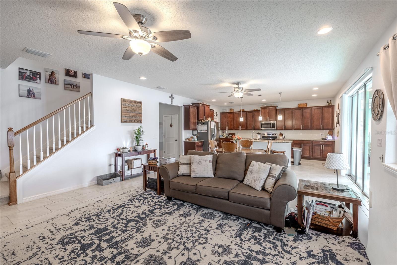 Open-concept family area with flexible furniture placement and views of the kitchen, making it perfect for gatherings.