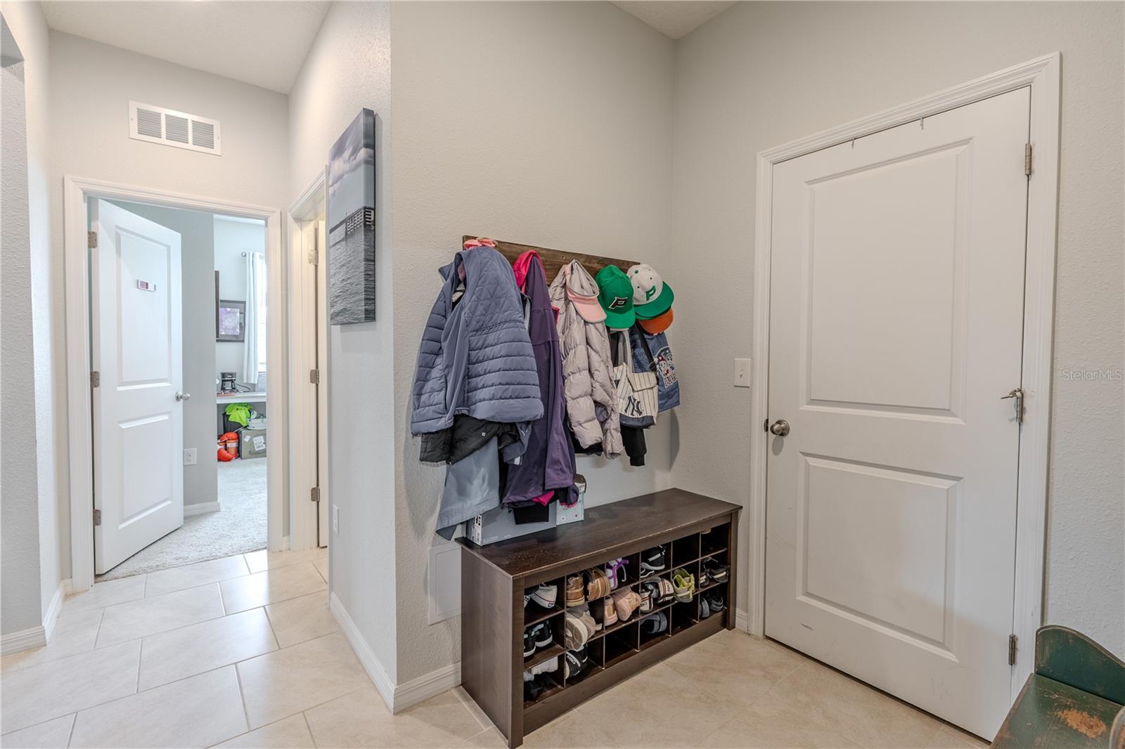 Entry from garage with built-in nook and large storage closet, perfect for keeping everyday items neatly organized.