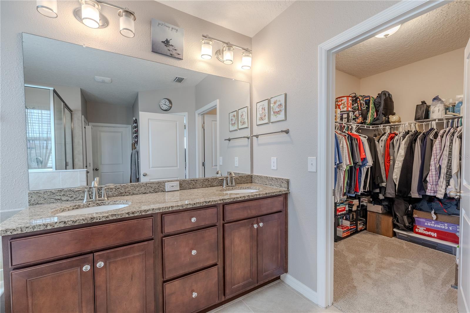 Dual walk-in closets in the primary suite provide excellent storage and organization with easy access from the ensuite bath.