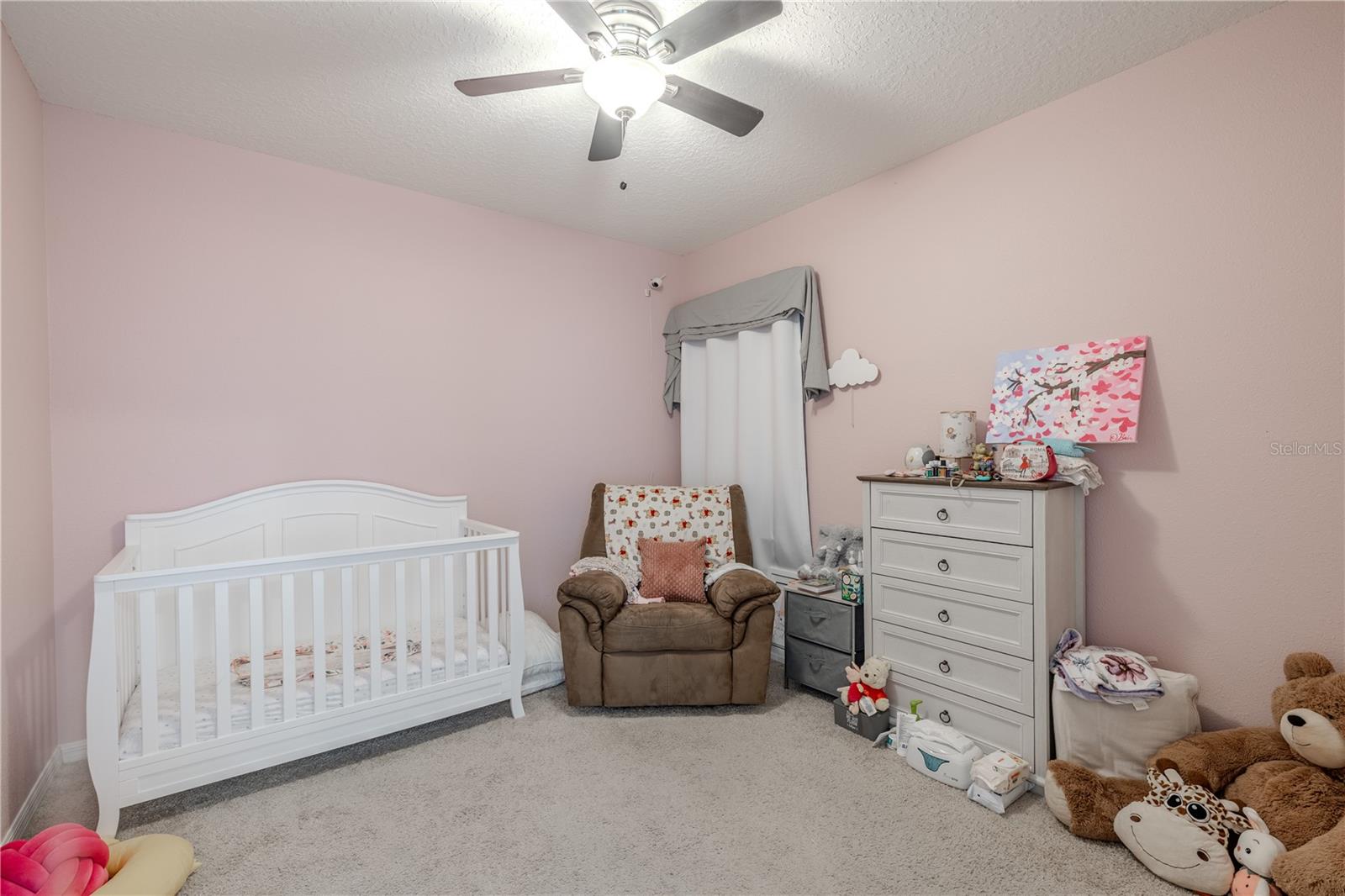 Bedroom 2 offers soft neutral tones and generous space, perfect for guests or a home office.