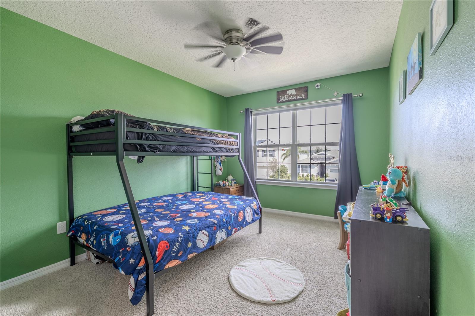 Bedroom 3 features bright natural light, a ceiling fan, and a huge walk-in closet for easy organization.