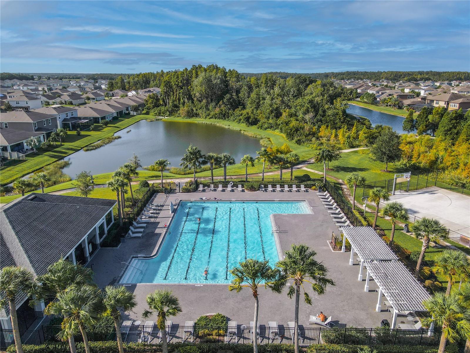 Community lap pool designed for exercise and leisure, surrounded by trees and open green space for a peaceful setting.